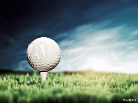 Picture of Golf ball placed on white golf tee on green grass golf course